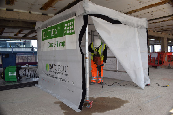 Carousel 1 - site operative drilling a concrete floor inside a dust trap enclosure 1