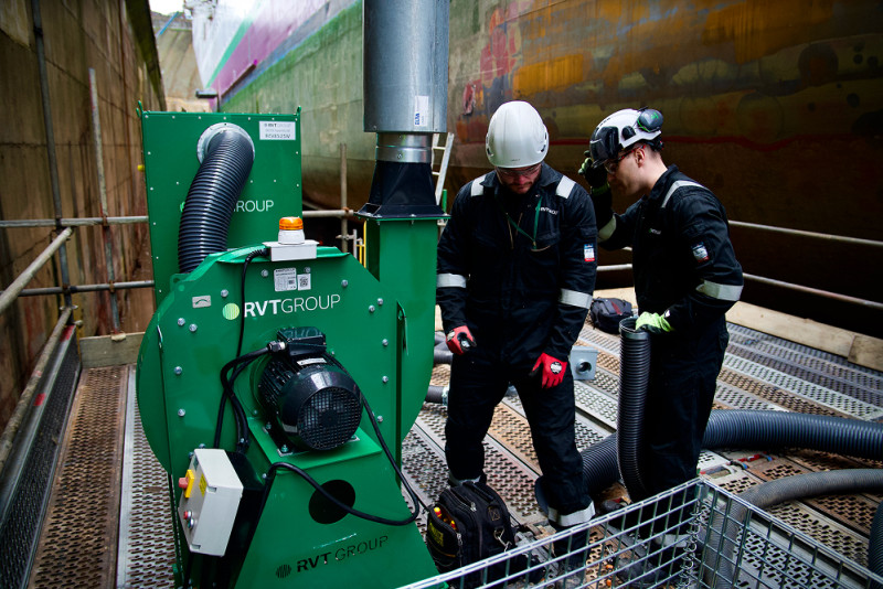 Defence - Two maintenance operatives alongside RVT Group's LEV sysyem which removes airborne hazards during maintenance and repair projects on naval ships 1