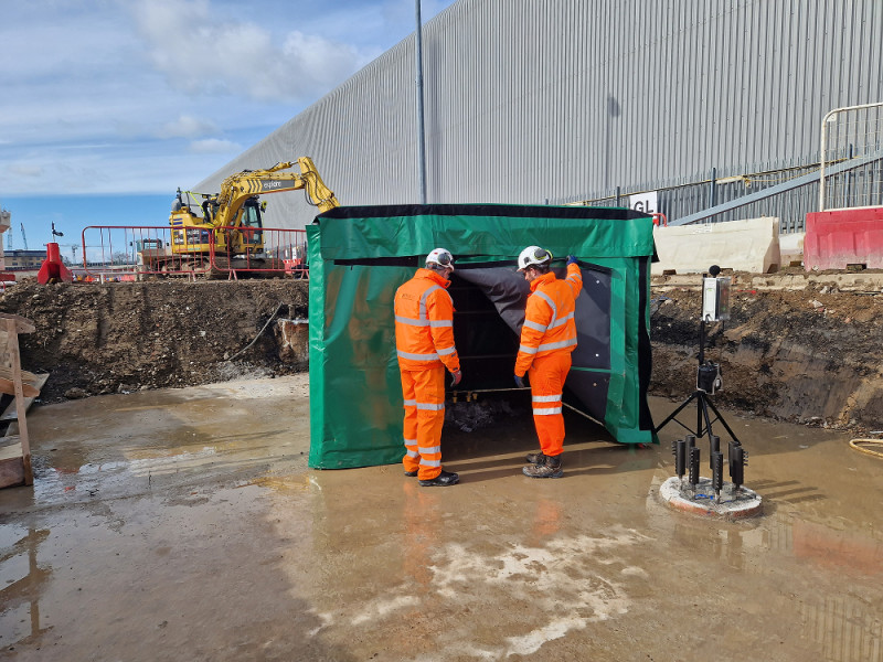 Infrastructure - Two infrastructure site operatives looking inside a seamless noise barrier installed on site 1