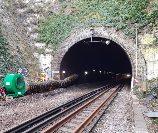 Carousel 4 - large centrifugal fan placed outside of a rail tunnel, using long lengths of ducting to provide workers inside the tunnel with fresh air 1