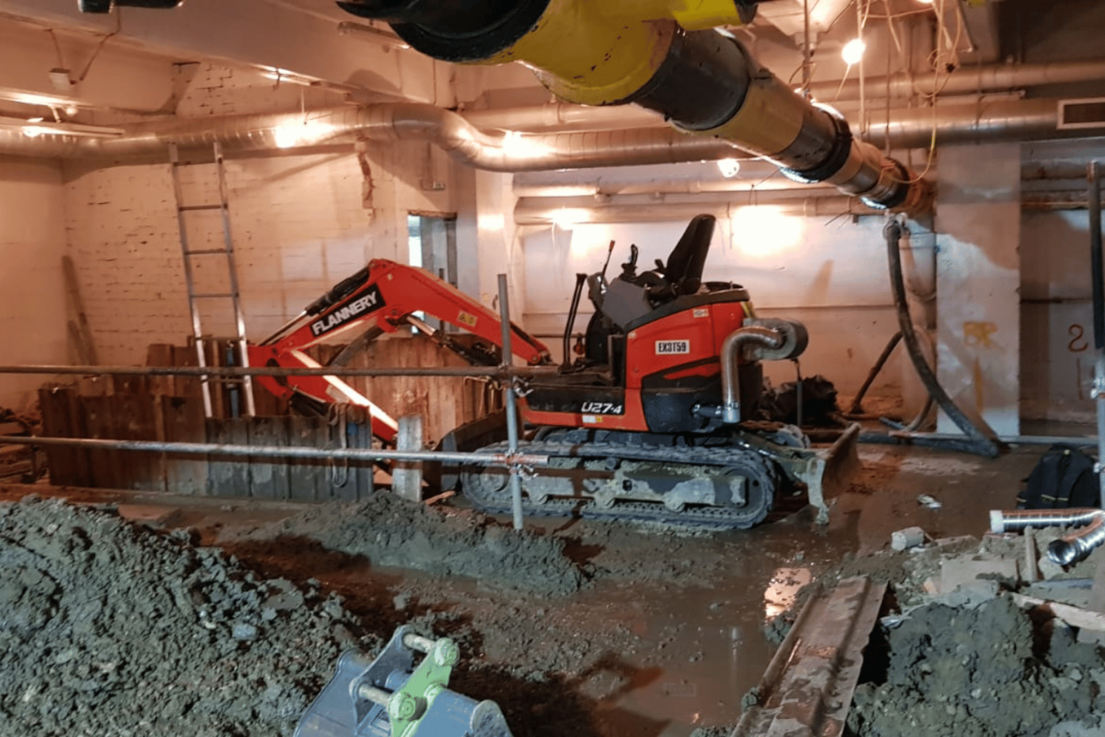 Ravex Diesel Filter Kit M60 on an excavator digging toward the back of a basement