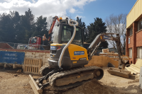 Ravex Diesel Filter Kit M60 twin kit on a compact excavator with waste materials around it