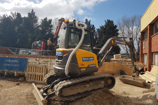 Ravex Diesel Filter Kit M60 twin kit on a compact excavator with waste materials around it