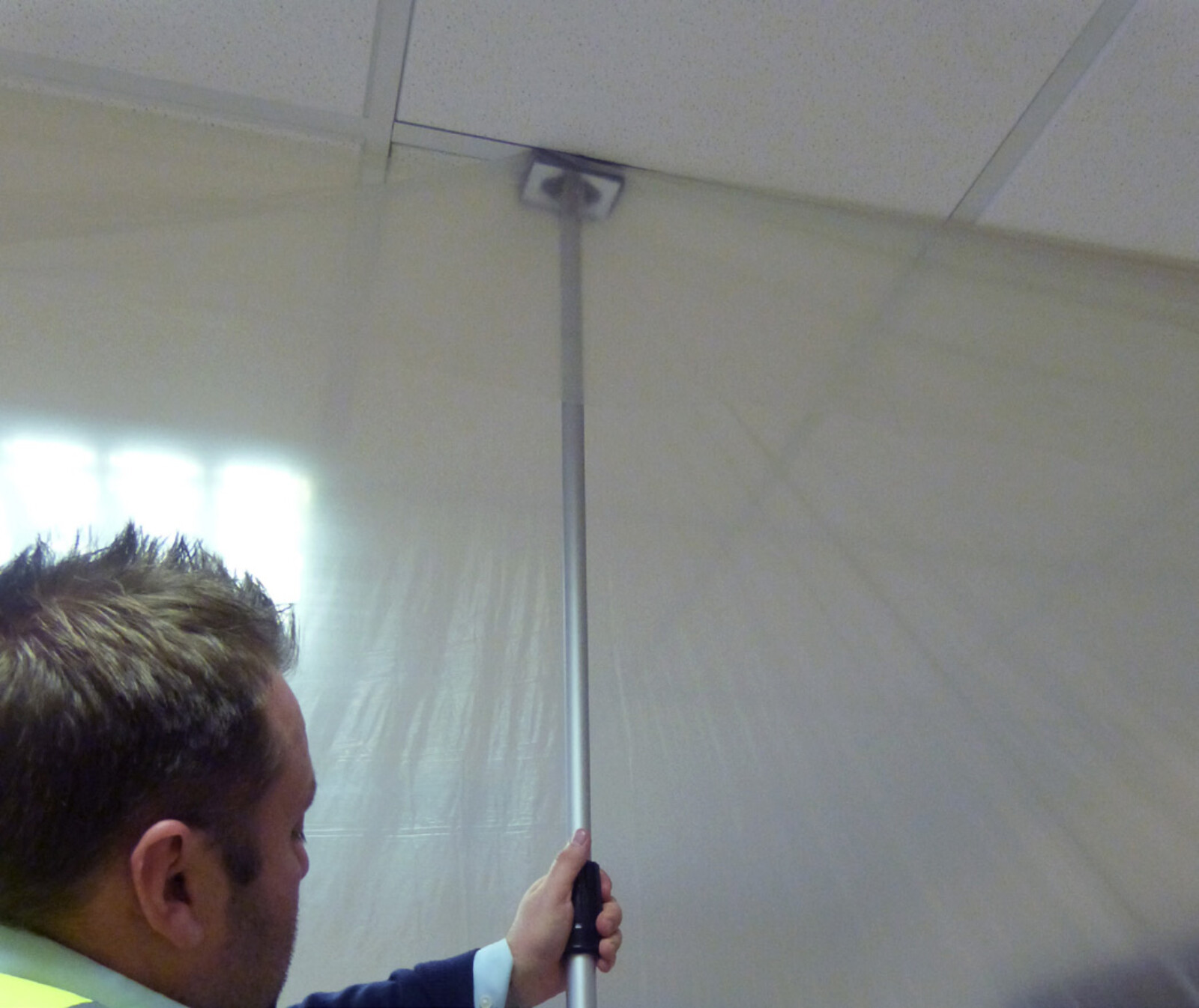 Dustex Quick Props in use to place dust sheets on a project