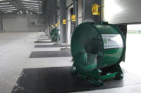 VENTEX Axial Fan 1250S in an industrial warehouse by a shutter slightly open to help force fresh air around the unit