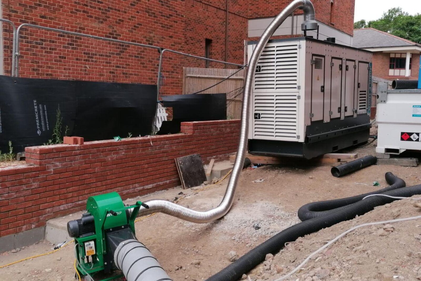 VENTEX Centrifugal Fan 300M making up part of an exhaust fume extraction system with metal piping going from the top of a nearby generator to the fan