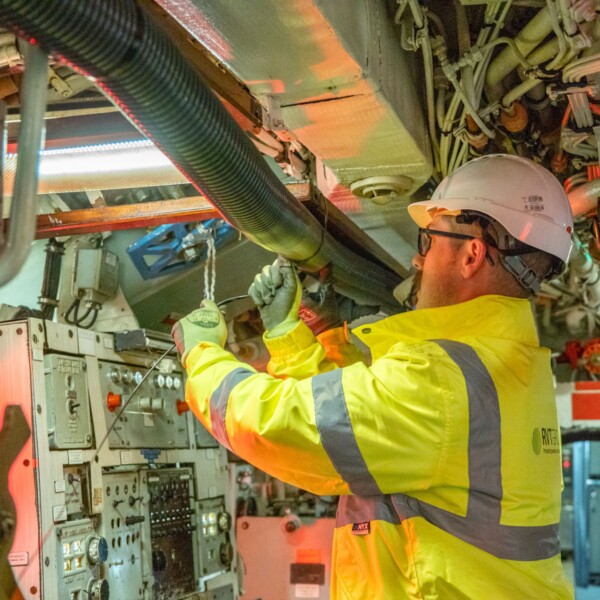 RVT Group engineer fitting ducting within an engine room